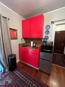 a kitchen with red cabinets and a stove at Serene Charming Private Suite Patio, Upscale Berkeley in Berkeley