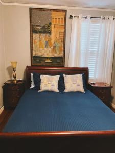 a bedroom with a large blue bed with two pillows at Serene Charming Private Suite Patio, Upscale Berkeley in Berkeley