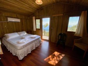 a bedroom with a bed in a room with wooden walls at Tree Houses Hotel in Fethiye