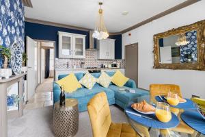 a living room with a blue couch and a table at Elberry at Dart Valley Coastal Apartments in Paignton