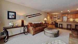 a living room with a couch and a table at Spacious One Bedroom Condo in Mammoth! Free Assigned Parking - Snowbird 107 in Mammoth Lakes