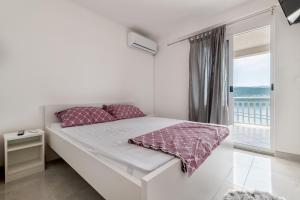 Postel nebo postele na pokoji v ubytování Apartmani Dodig