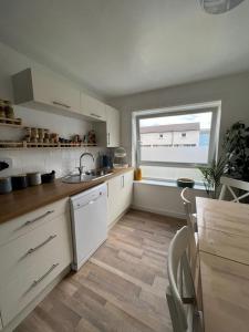 a kitchen with a sink and a window in it at Holyrood Duplex 3- Bedrooms Apartment in Edinburgh