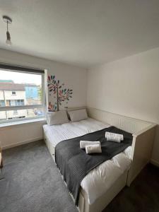 a bedroom with a large bed with two pillows on it at Holyrood Duplex 3- Bedrooms Apartment in Edinburgh