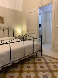 a bedroom with a bed and a large mirror at Dimora del Castellano CASA SATURNO in Gioia del Colle