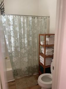 a bathroom with a shower curtain and a toilet at Quaint Cochella Music Festival Casita in Indio