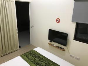 TV a/nebo společenská místnost v ubytování Four Seasons Homestay