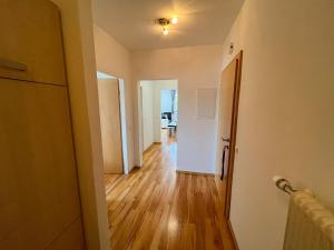 a hallway of an apartment with a hard wood floor at Ottl's Appartement O2 in Sankt Lorenzen ob Murau