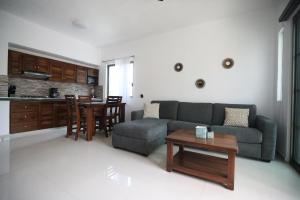 a living room with a couch and a table at Hotel Suites Del Mar in La Manzanilla