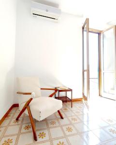 a living room with a chair and a table at Eco House San Michele in San Michele