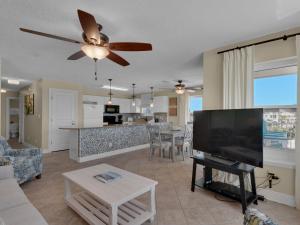 a living room with a large flat screen tv at Emerald Dunes 301 by Newman-Dailey in Destin