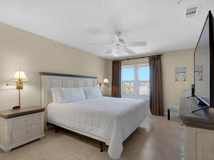 a bedroom with a white bed and a television at Emerald Dunes 301 by Newman-Dailey in Destin +46 photos