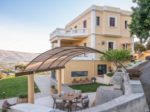 a building with a table and chairs in front of it at Mondethea vantage point home in Chania