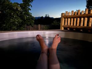 a woman laying on a pool with her feet in the water at Camping Porto Vecchio in Porto-Vecchio