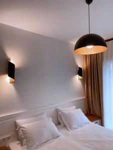 A bed or beds in a room at Amber Boutique Hotel