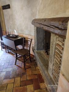 a dining room with a table and a fireplace at Dimore Santa Maria in Carbognano