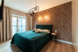 Tempat tidur dalam kamar di Mennica Residence Luxury Location