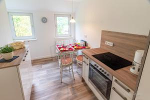 a kitchen with a table and a stove top oven at Ferienwohnung am Waldrand in Bad Laasphe