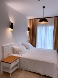 A bed or beds in a room at Amber Boutique Hotel