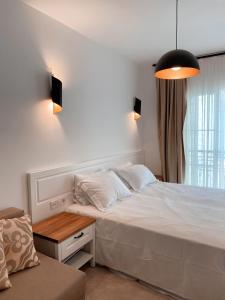 A bed or beds in a room at Amber Boutique Hotel