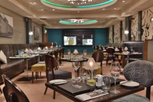 a dining room with tables and chairs and a room with at Westville Hotel in Enniskillen