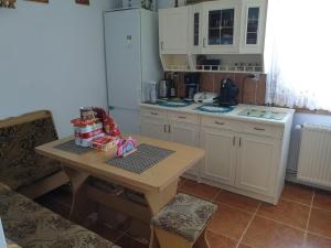 a small kitchen with a table and a counter top at A summer house Zarabie Domek letniskowy Zarabie in Myślenice