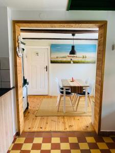 a dining room with a table and chairs at Ferienhaus am Seegrund in Ahlbeck +47 photos
