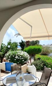 a table and chairs under an umbrella on a patio at Lovely 1-bedroom unit @ fabulous location in Paphos City