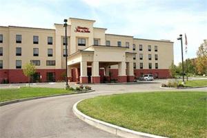 a large building with a parking lot in front of it at Hampton Inn & Suites Dayton-Airport in Englewood