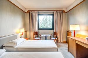 Postel nebo postele na pokoji v ubytování Hotel Della Rotonda