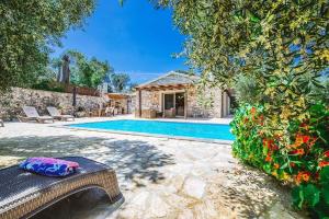 a villa with a swimming pool and a house at Aristea Villa by PaxosRetreats in Gaios