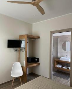 a room with a bed and a tv and a mirror at Why Not B&B in San Polo Matese