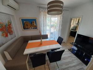 a living room with a table and a couch at Apartment Sandra in Dubrovnik