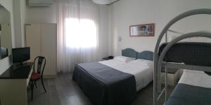 Postel nebo postele na pokoji v ubytování Hotel Capitol