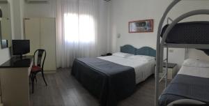 Postel nebo postele na pokoji v ubytování Hotel Capitol