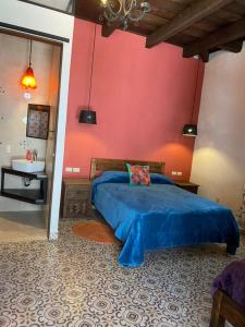 a bedroom with a blue bed and a sink at Casa Tequio in San Crist&oacute;bal de Las Casas