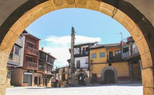 an archway in a city with a clock tower at Casa Carla in Sotoserrano