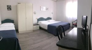 Postel nebo postele na pokoji v ubytování Hotel Capitol