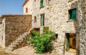 an old stone building with stairs and a plant at 1 Bedroom Gorgeous Apartment In Villagrande Di Monteco 
