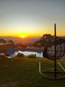 a sculpture of a helicopter in front of a sunset at Pousada Village Pôr do Sol in Campos do Jordão