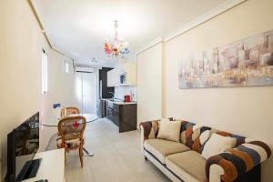 a living room with a couch and a table at Cuidadosamente decorado apartamento junto al metro in Madrid