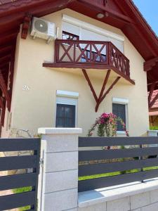 a house with a balcony on the side of it at Aranypatkó Vendégház Lovasudvar in Berzence