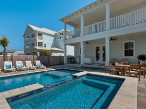 a swimming pool in front of a house at Blessings by the Beach by Newman-Dailey in Destin
