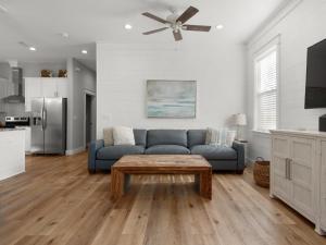 a living room with a blue couch and a table at Blessings by the Beach by Newman-Dailey in Destin