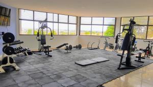 a gym with several treadmills and exercise machines at Dulcinea Mini House in Salinas