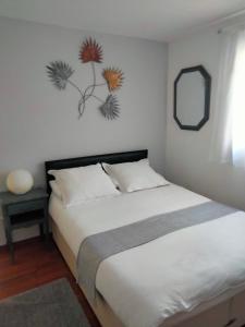 1 dormitorio con cama y espejo en la pared en beautiful apartment with garden, en Amélie-les-Bains-Palalda
