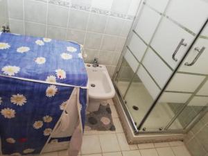a bathroom with a shower and a toilet with a shower curtain at St.Giovanni House in Alghero