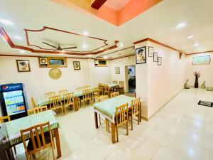 a restaurant with tables and chairs in a room at Grand view lodge and Restaurant Dharamshala - Partial Prepayment required to confirm booking in Dharamshala