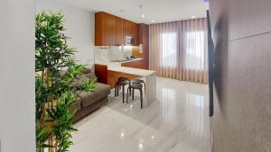 a kitchen with a couch and a table and chairs at Seven Seas Apartments in Nazaré