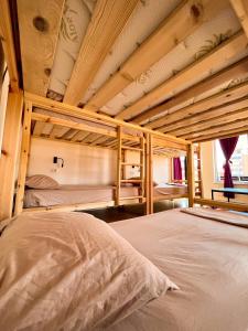a bedroom with two bunk beds in a room at Blue Door Hostel in Tirana